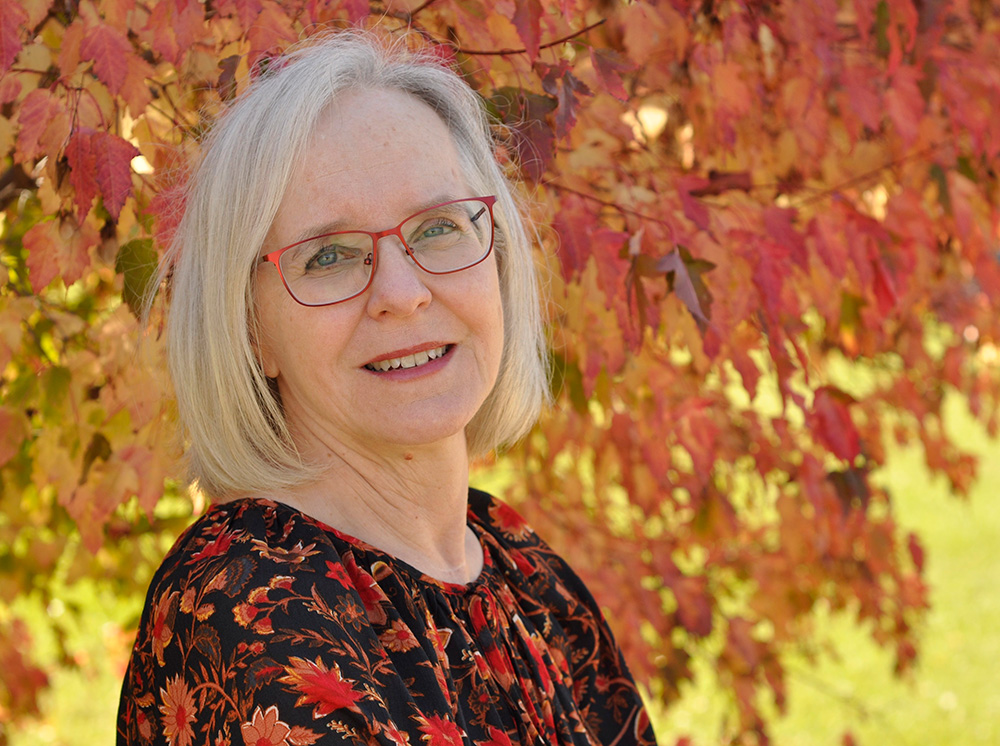 Photo: Patti Grayson in front of fall foliage